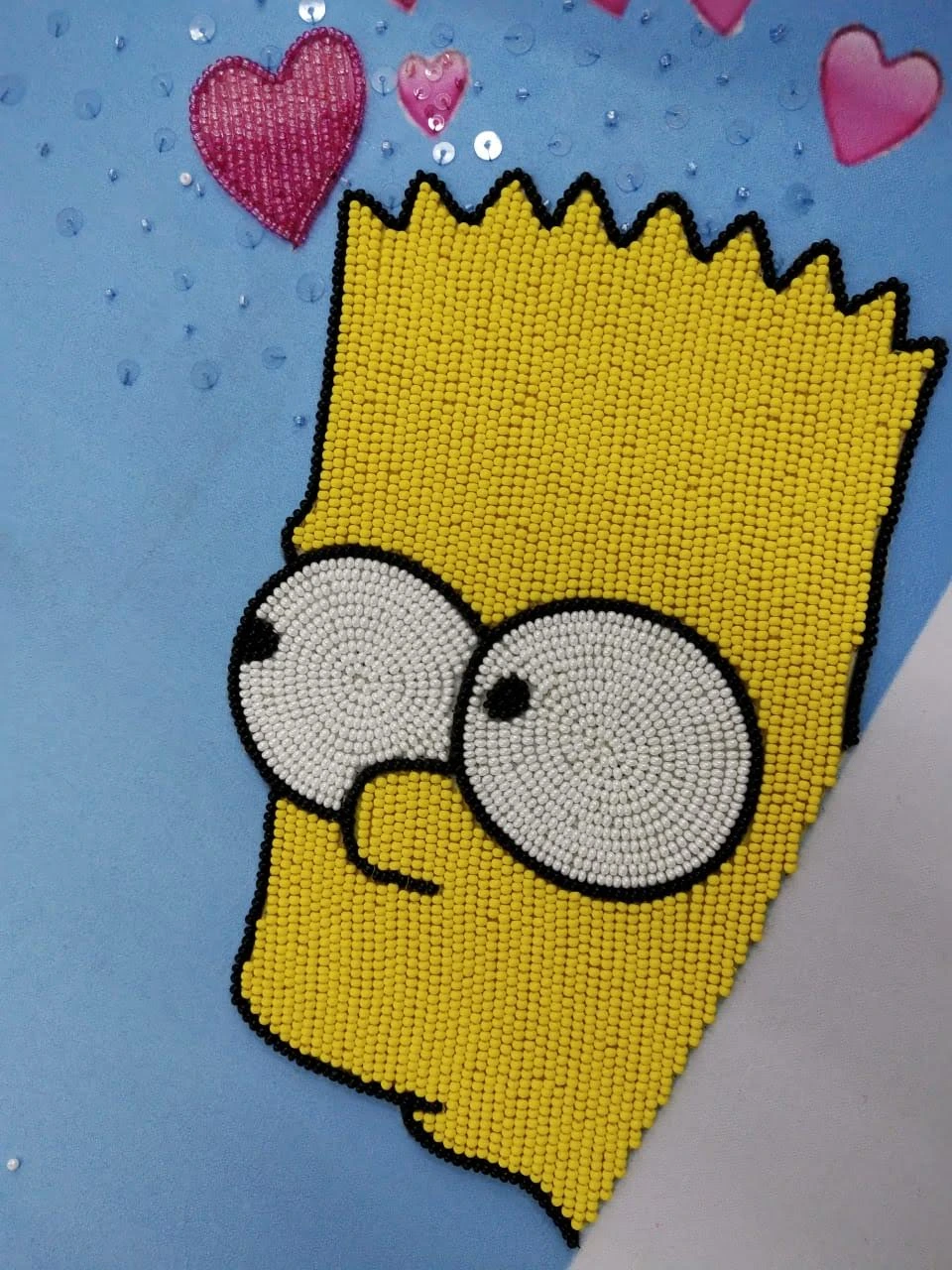 The artist's Bart Simpson portrait, made with yellow, black and white beads