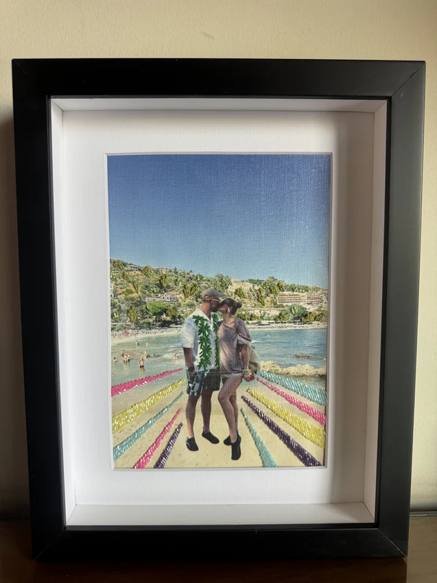 Framed seaside couple photograph with colourful stitched rays and embroidered leaves