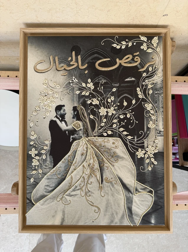 Framed wedding portrait with gold lettering, ivory shell flowers and pearl embroidery following the wedding dress